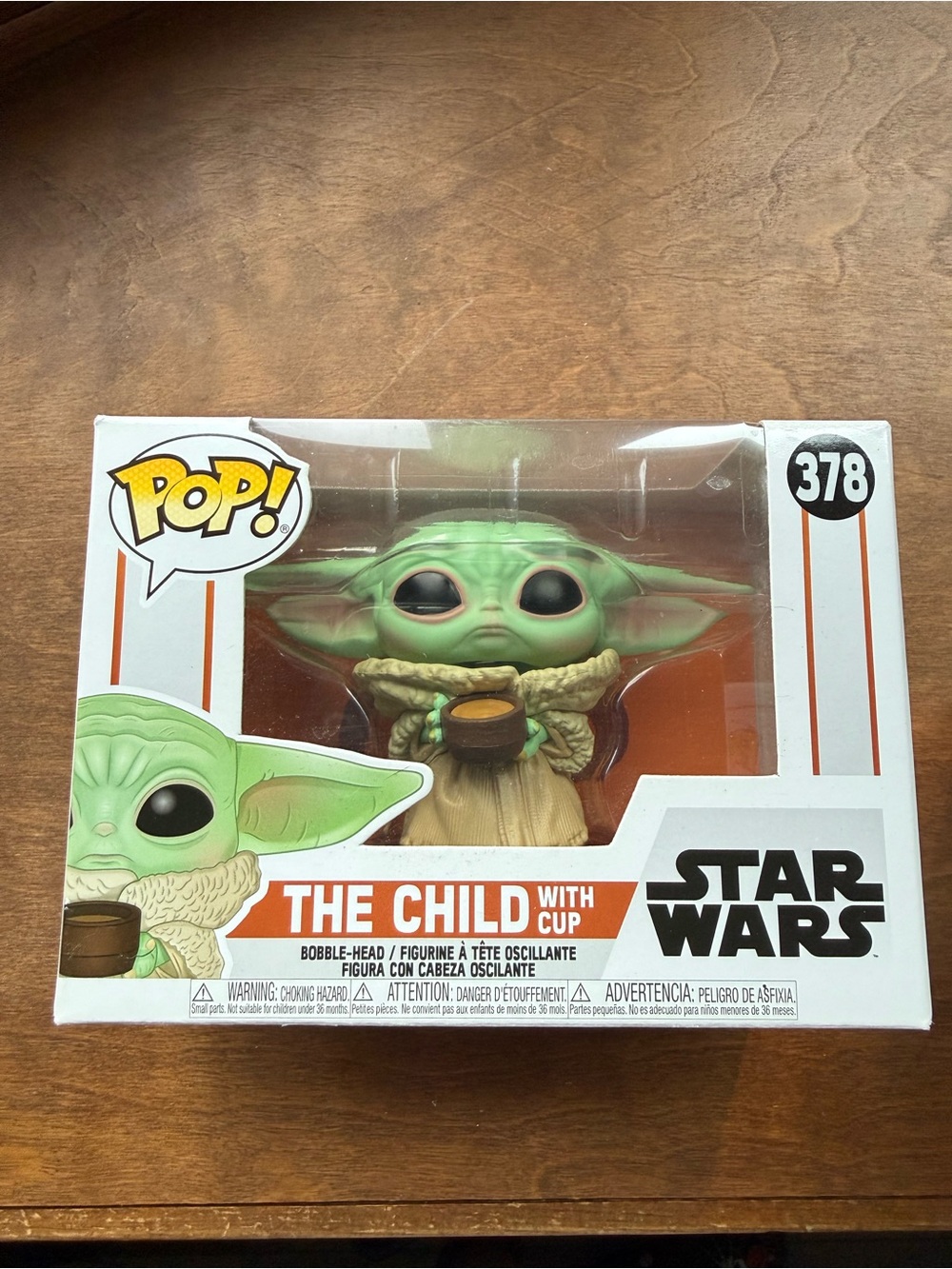 pop The Child Figure holding cup - green and tan